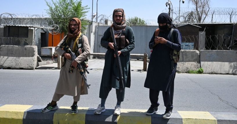 Taliban fighters stand guard along a street in Kabul on Monday after a stunningly swift end to Afghanistan's 20-year war, as thousands of people mobbed the city's airport trying to flee the group's feared hardline brand of Islamist rule.
