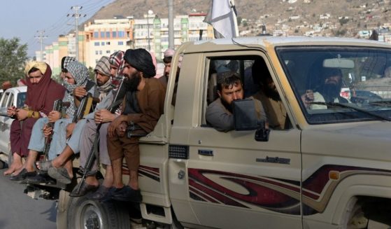 Taliban fighters in a vehicle patrol the streets of Kabul on Monday.