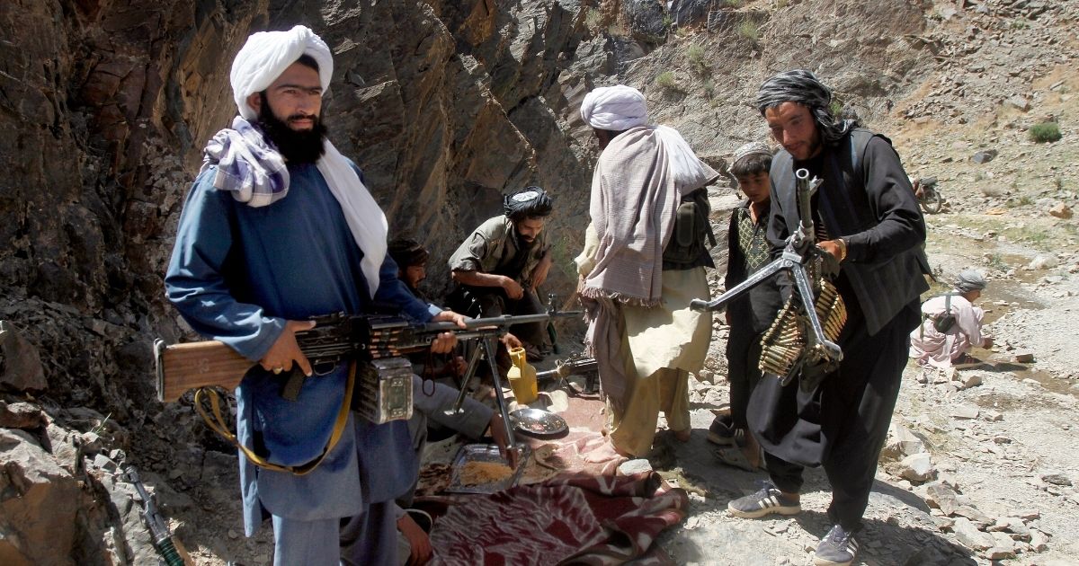 In this May 27, 2016, file, photo, members of a breakaway faction of the Taliban fighters prepare to guard a gathering in the Shindand district of Herat province, Afghanistan.