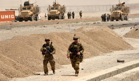 U.S. soldiers walk at the site of a Taliban suicide attack in Kandahar on Aug. 2, 2017.
