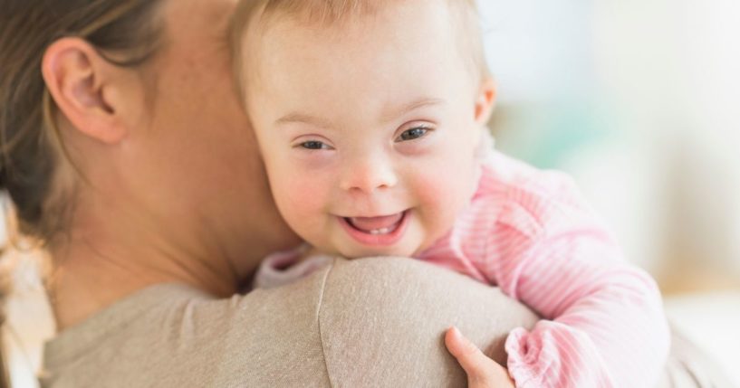 In this stock photo, a woman is seen holding a baby with Down syndrome. Pro-abortion groups filed a lawsuit Tuesday seeking to overturn a new Arizona law that would ban abortions because of Down syndrome or other genetic abnormalities. (