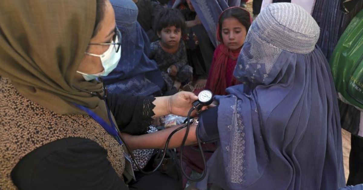 A woman is seen having her blood pressure taken at a public park in Kabul, Afghanistan, on Aug. 10, 2021.