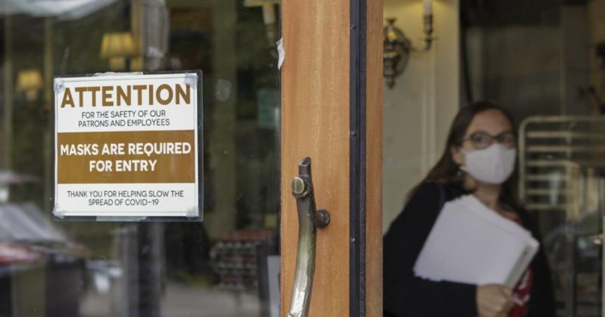 A photo taken on May 21, 2021, shows a sign telling people to wear masks at a bakery in Lake Oswego, Oregon.
