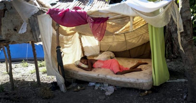 A woman sleeps outside in Saint-Louis-du-Sud, Haiti, on Monday.