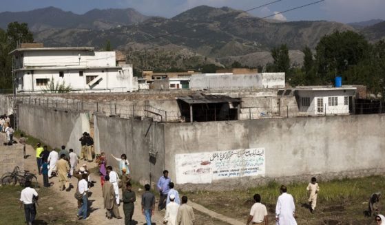 On May 3, 2011, people gather outside Osama bin Laden's compound, where he was killed the previous day during a raid by U.S. special forces in Abbottabad, Pakistan.