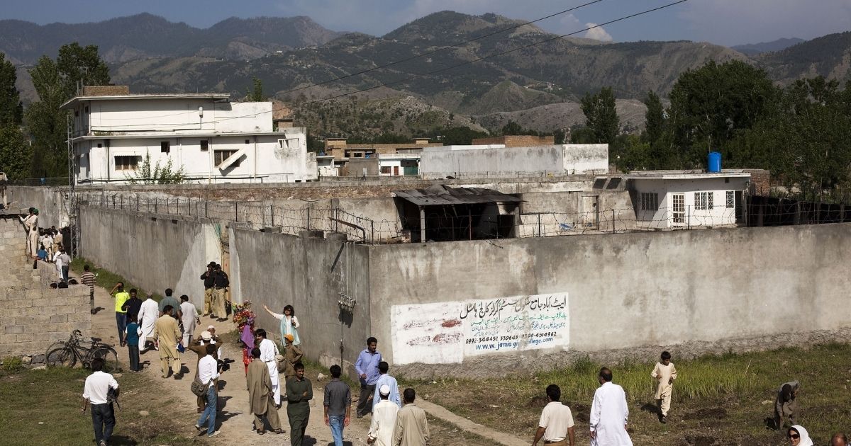 On May 3, 2011, people gather outside Osama bin Laden's compound, where he was killed the previous day during a raid by U.S. special forces in Abbottabad, Pakistan.