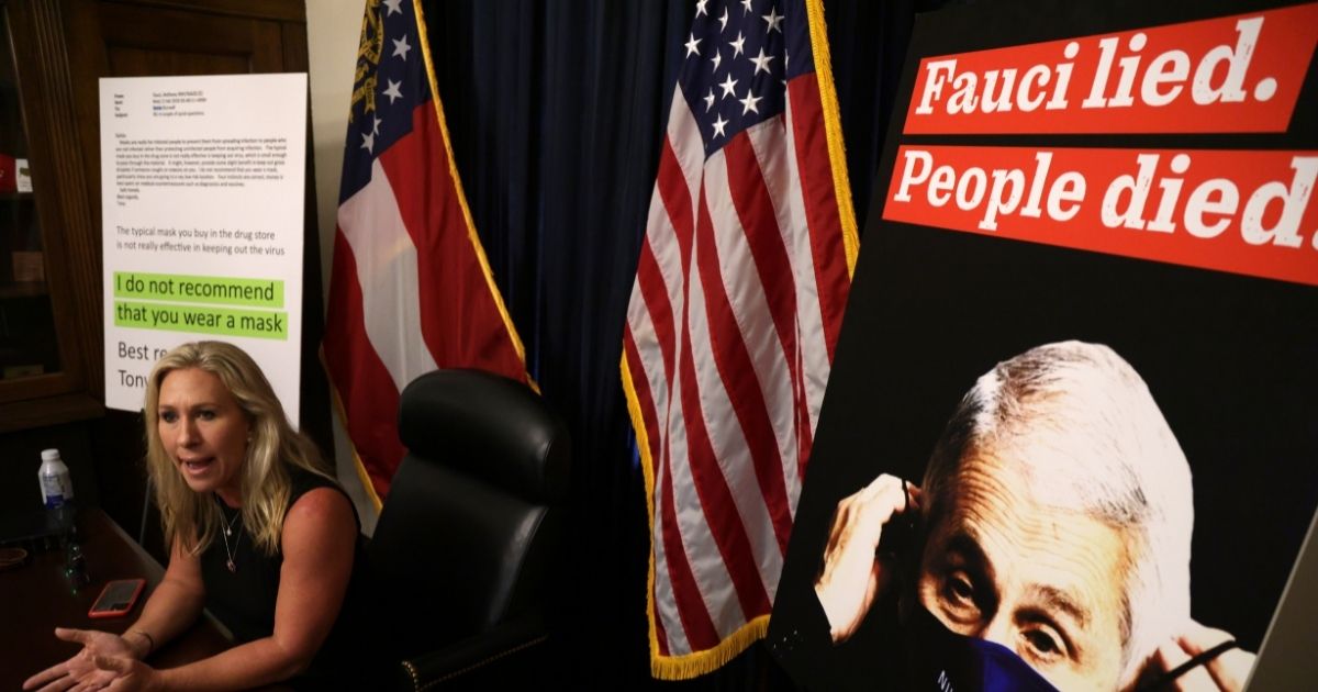 U.S. Rep. Marjorie Taylor Greene, a Republican from Georgia, speaks during a news conference in her office in Washington, D.C., on July 20, 2021, with a poster of Dr. Anthony Fauci nearby. Critics of Fauci, the director of the National Institute of Allergy and Infectious Diseases, say he has given inconsistent information to the public about the coronavirus.
