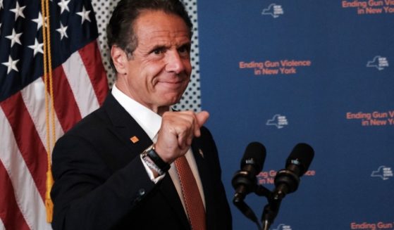 New York Gov. Andrew Cuomo pumps his fist in a file photo from a July news conference about crime in New York City.