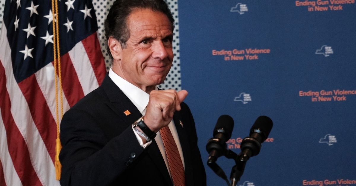 New York Gov. Andrew Cuomo pumps his fist in a file photo from a July news conference about crime in New York City.