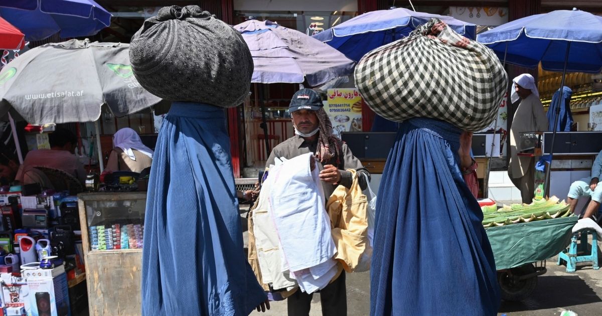 Women covered in burqas leave a market in Kabul in June, prior to the Taliban takeover.