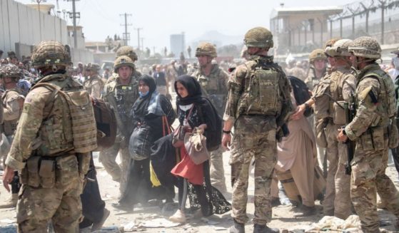 n this handout image from the Ministry of Defence, British armed forces work with the U.S. military to evacuate civilians and their families from Afghanistan on Aug. 21, 2021.