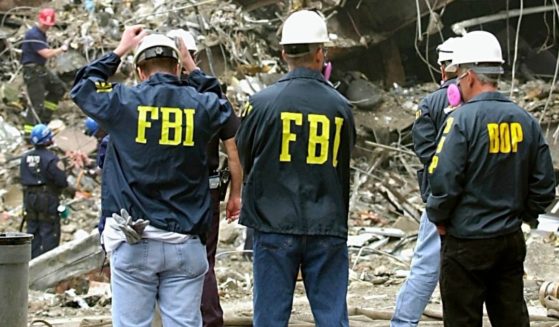 FBI agents stand before the wreckage of the World Trade Center in a 2001 file photo.