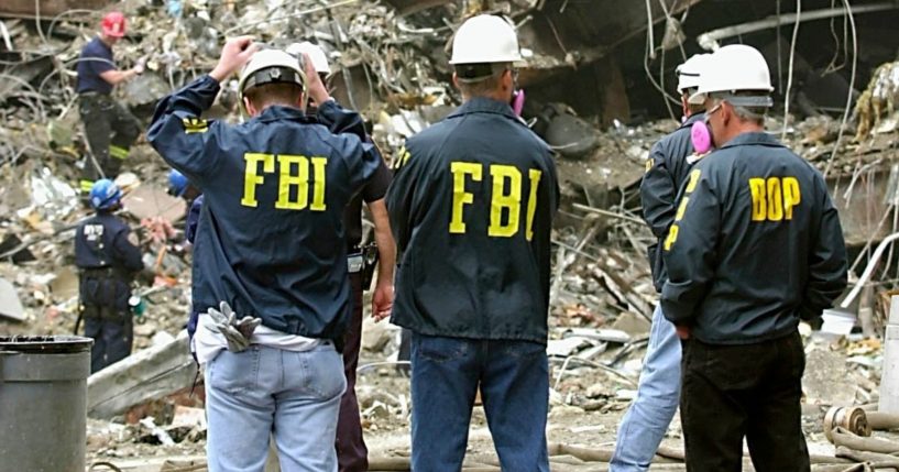 FBI agents stand before the wreckage of the World Trade Center in a 2001 file photo.
