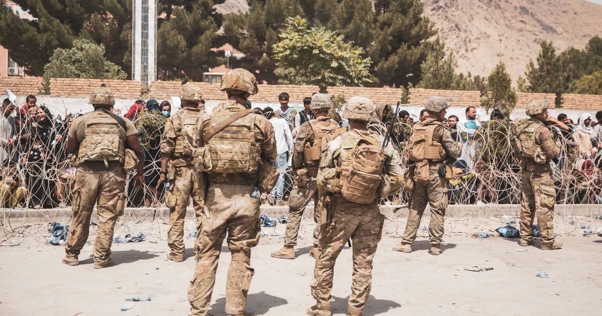 A handout photo from the United States Marine Corps shows Marines and American soldiers guarding Hamid Karzai International Airport in Kabul, Afghanistan, on Aug. 19. On Wednesday evening, The U.S. Embassy warned Americans in Kabul not to go to the airport.