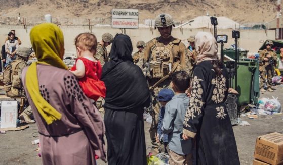 In an image provided by the U.S. Marine Corps, Marines process evacuees Hamid Karzai International Airport in Kabul, Afghanistan, on Saturday.