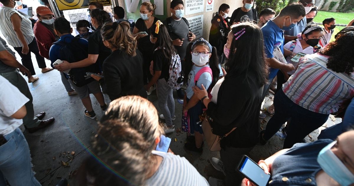 Students and parents at Grant Elementary School in Los Angeles kick off the school year complying with rules requiring masks inside school buildings in an Aug. 16 photo.