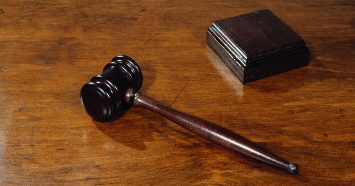 A gavel lies next to a sound block in this stock photo.
