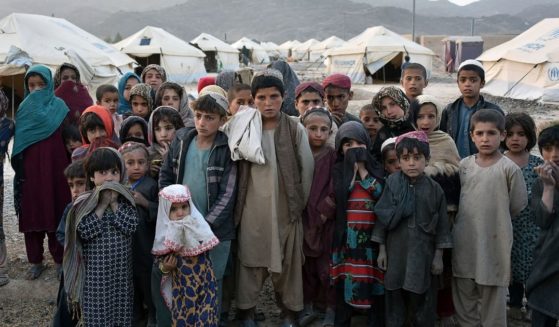 Children stand in front of tents in the Panjwai district of the Kandahar province in Afghanistan on March 31, 2021.