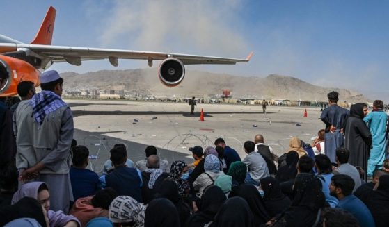 A crowd of Afghan people is seen sitting at the airport in Kabul in Afghanistan on Monday.