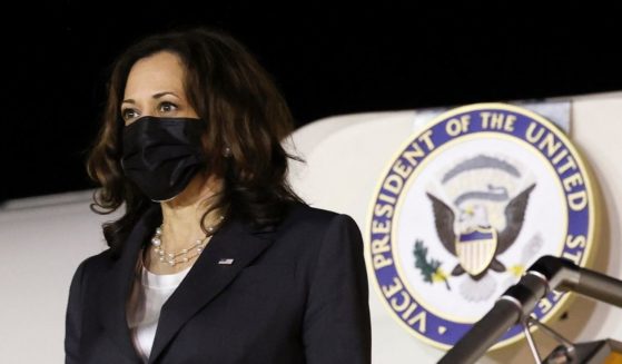 Vice President Kamala Harris stands next to a plane at the airport in Hanoi, Vietnam, on Tuesday.