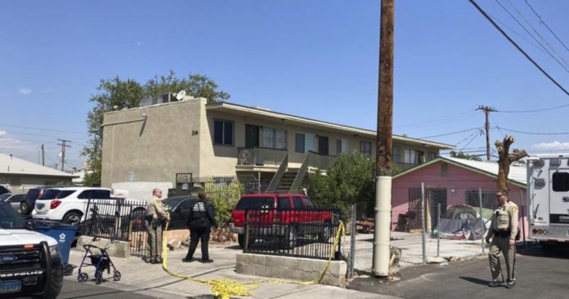 Las Vegas police are seen standing outside the apartment where the shooting occurred in this photo taken on Tuesday.