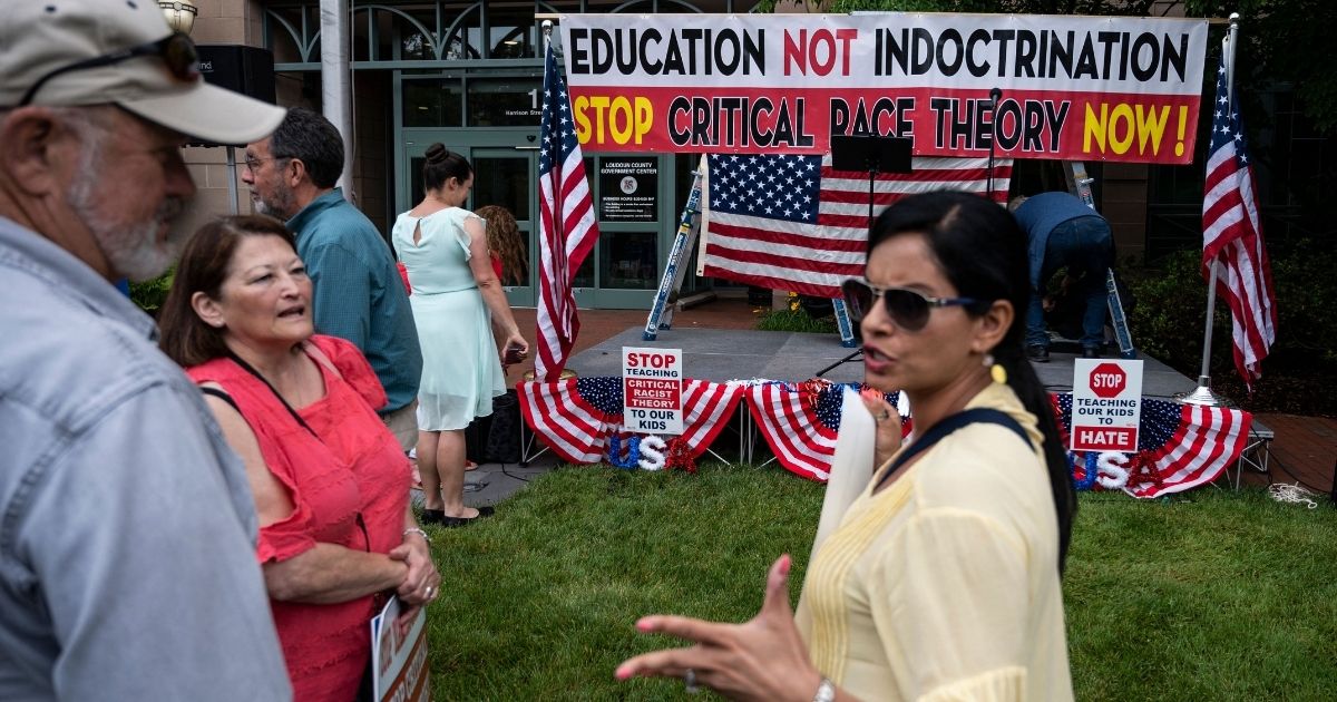People talk at a rally against critical race theory in Leesburg, Virginia, on June 12, 2021.