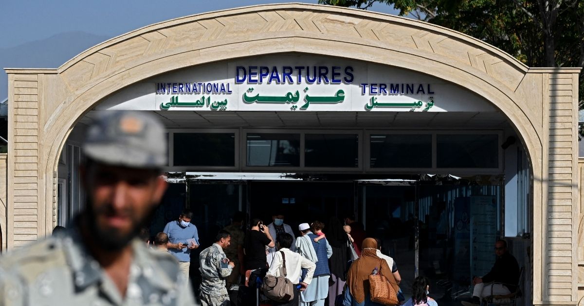 Passengers enter the departures terminal of the Hamid Karzai International Airport in Kabul on July 17.