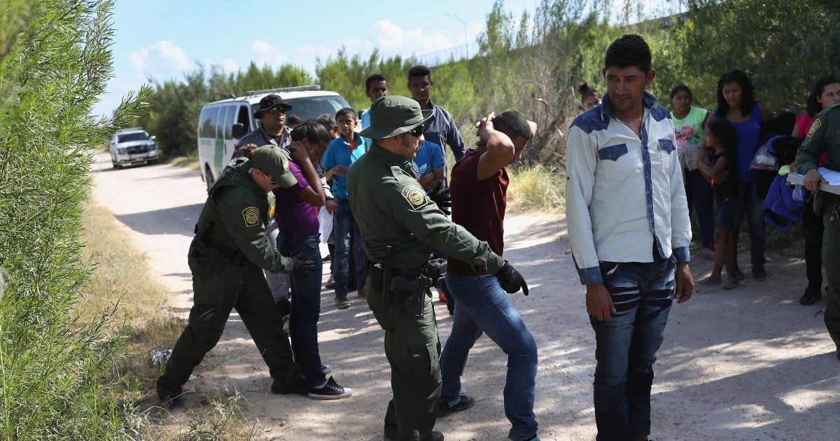 Border Patrol agents take a group of Central American asylum seekers into custody on June 12, 2018, near McAllen, Texas.