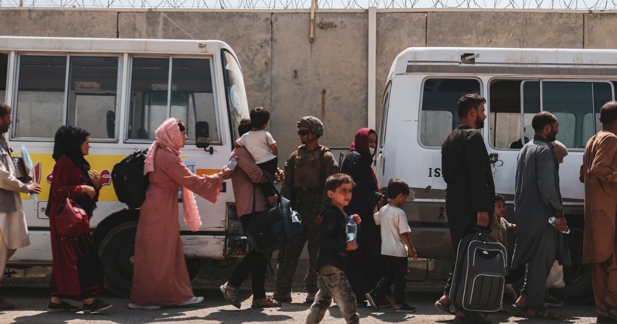 In this handout provided by the U.S. Marine Corps, evacuees board buses for processing at Hamid Karzai International Airport during the evacuation on Aug. 21, in Kabul, Afghanistan.
