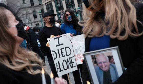 People who've lost loved ones due to COVID-19 while they were in New York nursing homes attend a protest and vigil on March 25, 2021, in New York City.