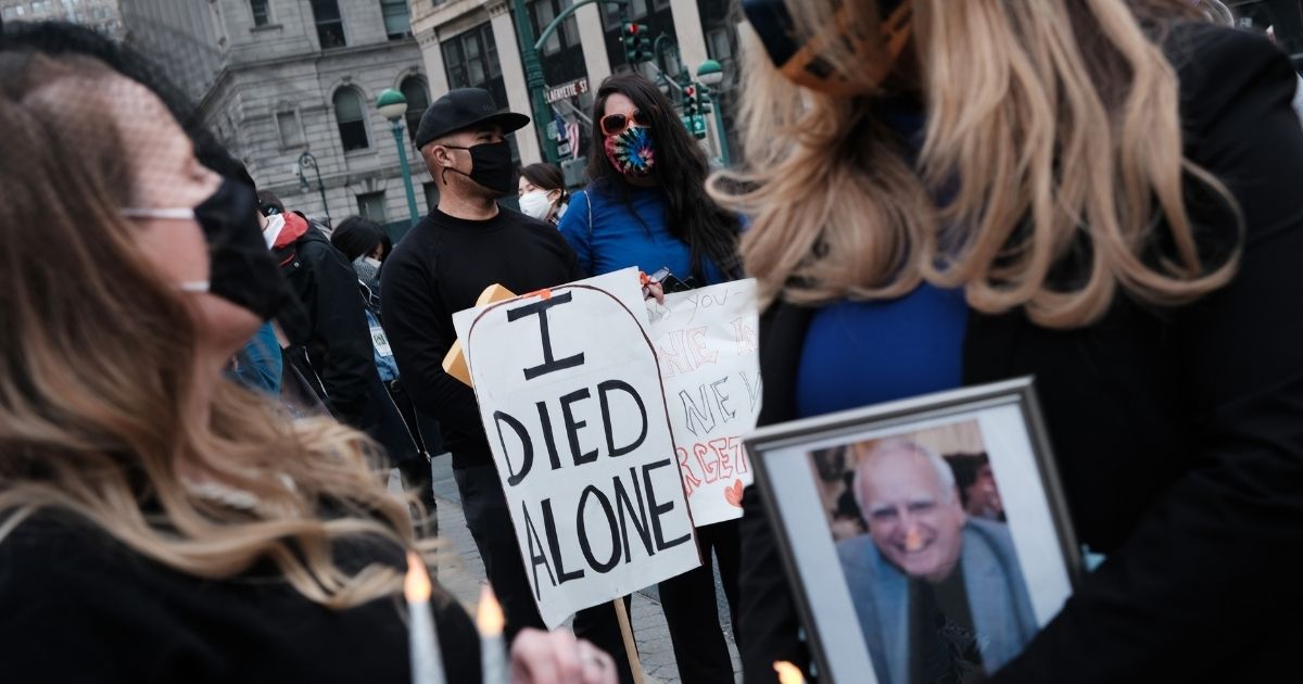 People who've lost loved ones due to COVID-19 while they were in New York nursing homes attend a protest and vigil on March 25, 2021, in New York City.