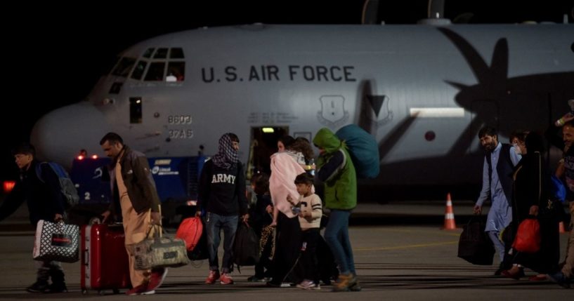 Afghan refugees exit a US Air Force plane at the Pristina International Airport in Pristina, Kosovo, on Sunday.