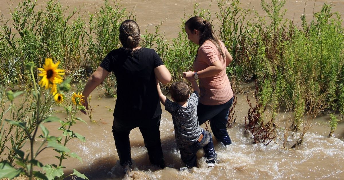 Migrants from Brazil cross the Rio Grande in Ciudad Juarez, State of Chihuahua, Mexico, on June 12, 2019, before turning themselves into U.S. Border Patrol agents to claim asylum.