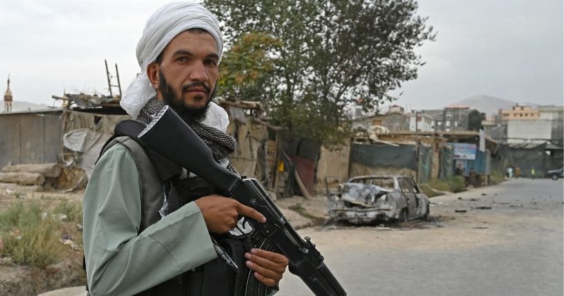 A Taliban fighter is seen standing with a weapon in Kabul, Afghanistan, on Monday.