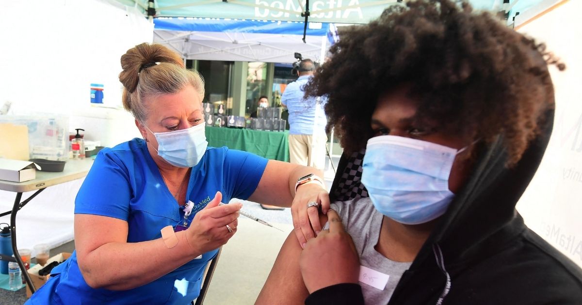 Registered Nurse Amy Berecz-Ortega from AltaMed Health Services administers the Covid-19 vaccine in Los Angeles, California on Tuesday.