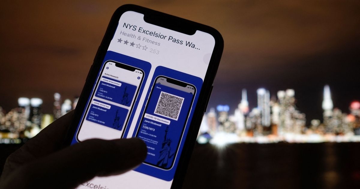 This illustration photo taken in Los Angeles on April 6, 2021, shows a person looking at the app for the New York State Excelsior Pass, which provides digital proof of a COVID-19 vaccination.