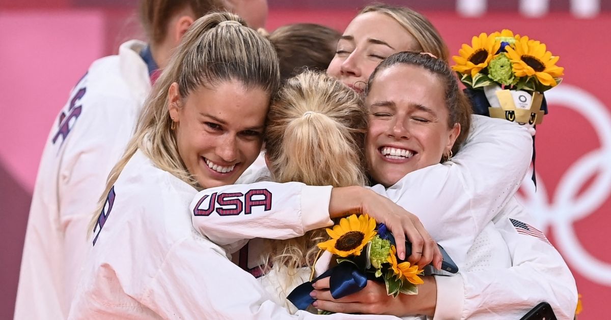 Andrea Drews, left, celebrates on the medal stand with her teammates after the U.S. won gold in women's volleyball during the Tokyo Olympic Games at Ariake Arena in Tokyo on Sunday.