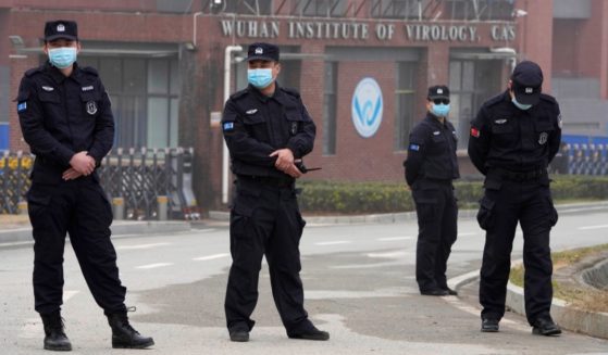 Security personnel gather near the entrance of the Wuhan Institute of Virology during a visit by the World Health Organization team in Wuhan in China's Hubei province on Feb. 3, 2021.