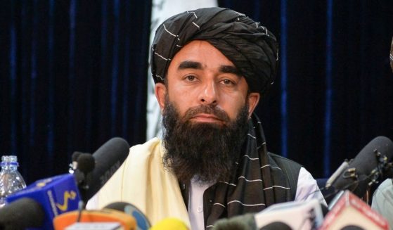 Taliban spokesperson Zabihullah Mujahid looks on as he addresses the first news conference in Kabul on Tuesday following the Taliban's takeover of Afghanistan.