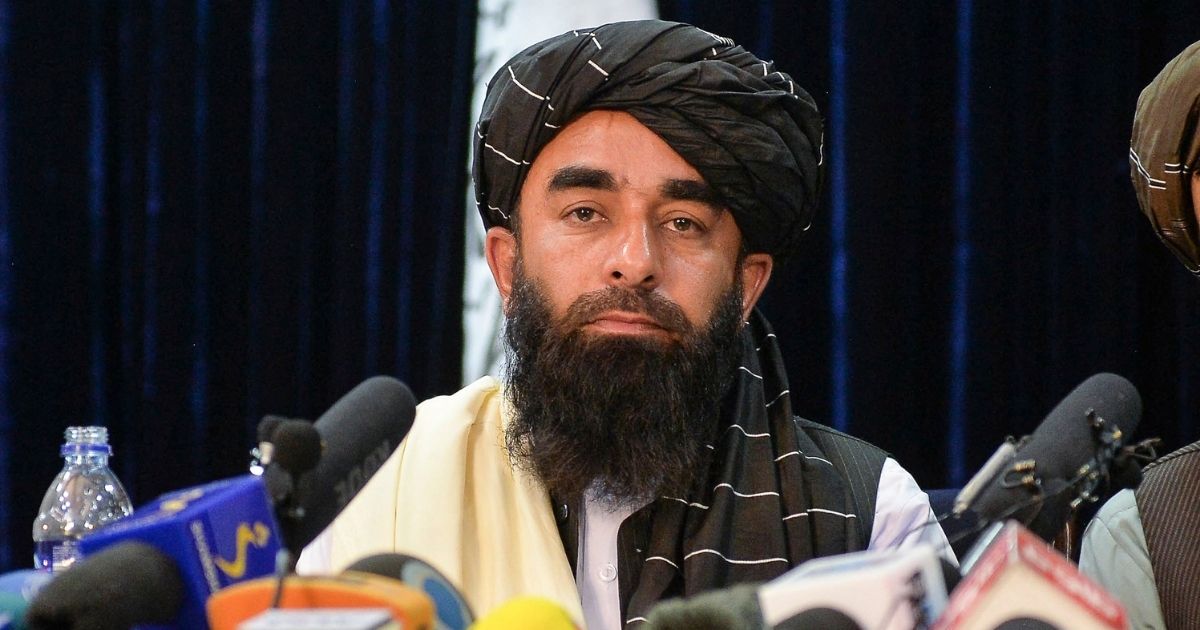 Taliban spokesperson Zabihullah Mujahid looks on as he addresses the first news conference in Kabul on Tuesday following the Taliban's takeover of Afghanistan.