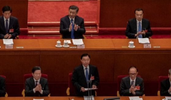 Chinese President Xi Jinping, upper row, center, applauds during the March meeting of the Chinese National People's Congress at the Great Hall of the People in Beijing.
