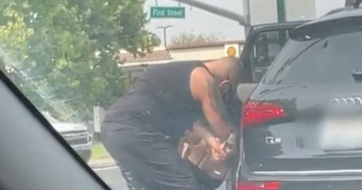 Off-duty police officer Gilbert Troche performs CPR on a baby after seeing its frantic mother pulled to the side of the road in Livermore, California.