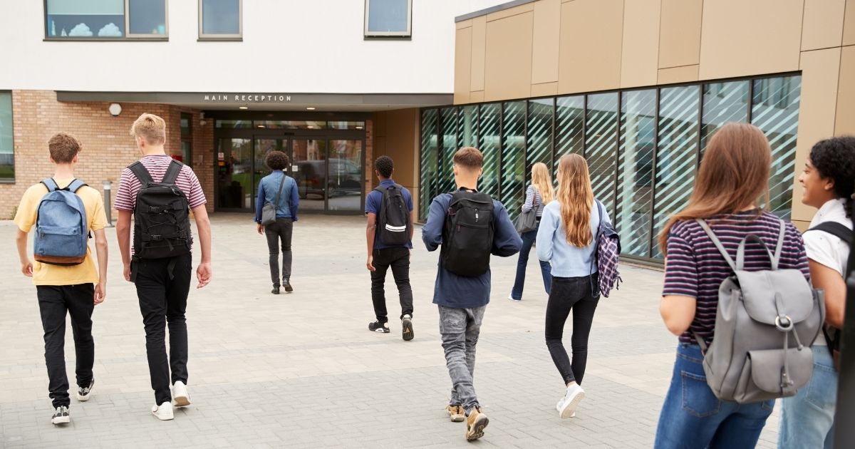 Students are seen walking into a school in the above stock image.