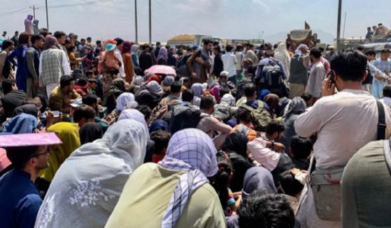 Throngs gather outside the airport in Kabul, desperate to escape the Taliban rule.