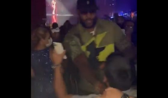 NBA start LeBron James pushes a fan out of the way Friday night at an Usher concert in Las Vegas.