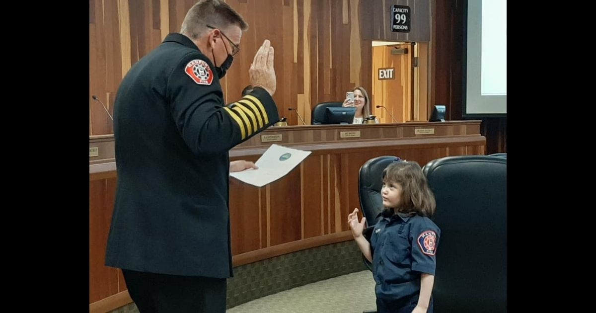 Penny Saltray, 7, is sworn in as an honorary firefighter with the Hanford Fire Department during a special ceremony on Tuesday.