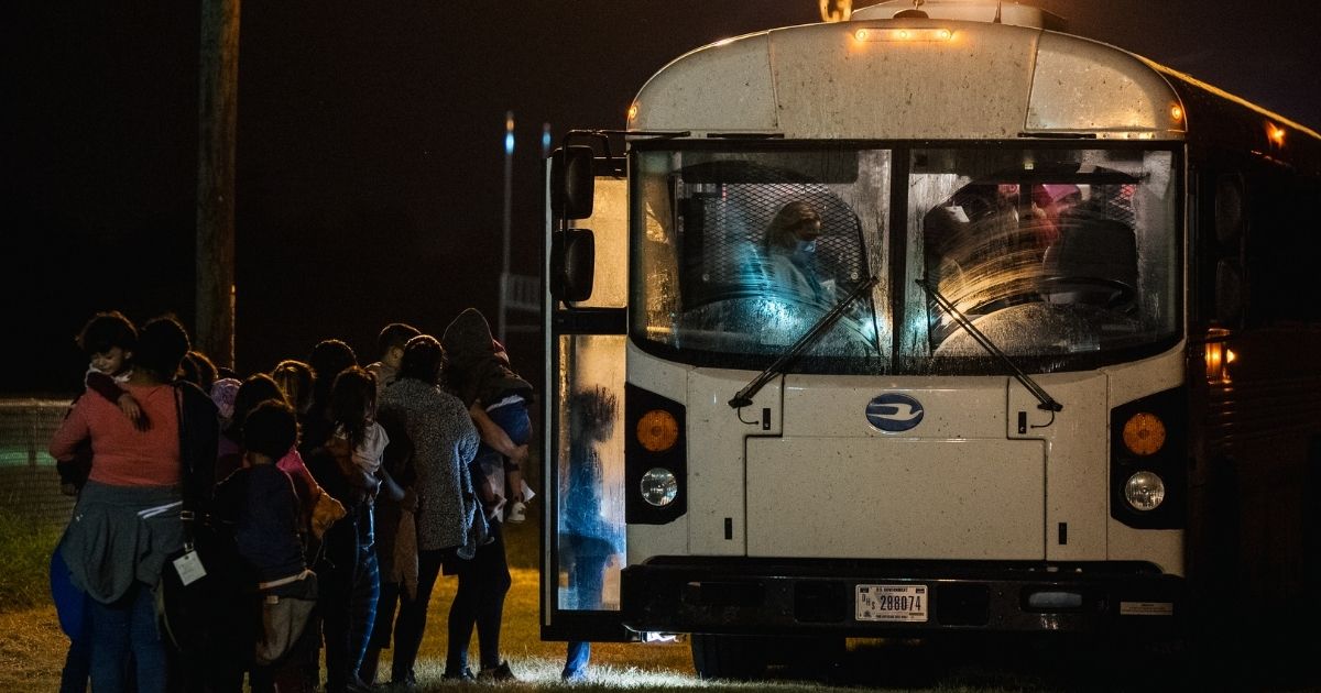 Migrants board a bus to be taken to a Border Patrol processing facility after crossing the Rio Grande into the U.S. on June 21, 2021, in La Joya, Texas.