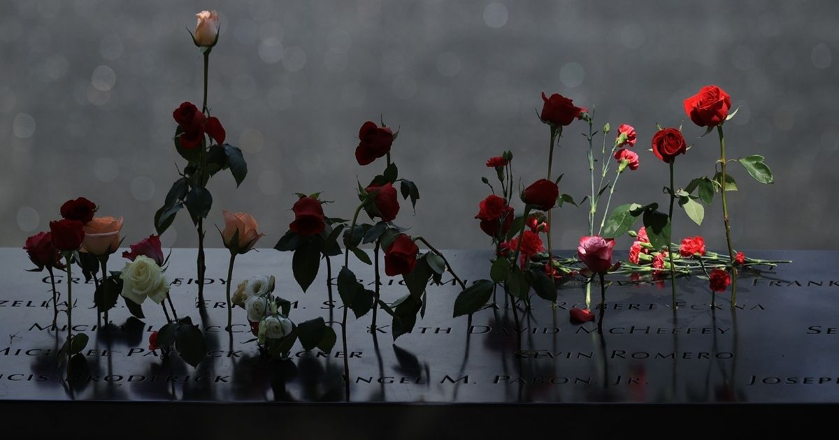 Flowers are placed into the inscribed names of the victims of the 9/11 attacks and in the 1993 World Trade Center bombing during the annual commemoration ceremony at the National 9/11 Memorial and Museum on Sept. 11, 2021 in New York City.