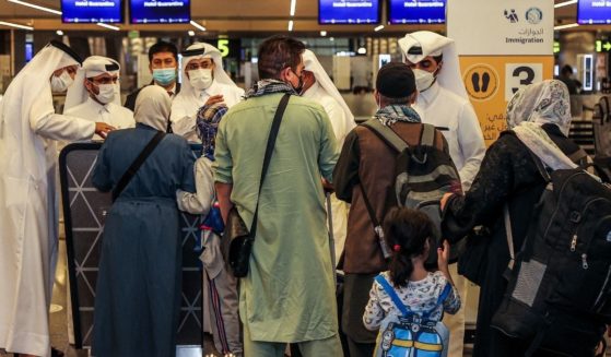 Evacuees from Afghanistan arrive inside the terminal at Hamad International Airport in Qatar's capital Doha on Thursday on the first flight carrying foreigners out of the Afghan capital since the conclusion of the U.S. withdrawal last month.