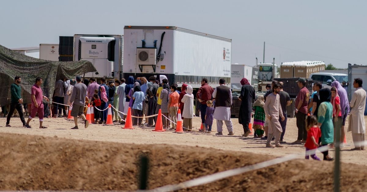 Afghan refugees line up for food outside a dining hall at Fort Bliss' Doña Ana Village, where they are being housed in Chaparral, N.M., on Sept. 10, 2021.